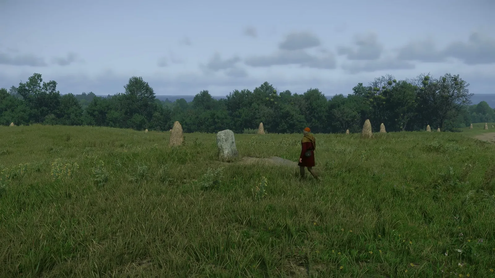 Captura del juego: un peregrino llega por el prado a rezar ante una piedra del camino.